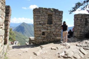 Machu-Picchu-sun-gate-Tracie-by-stone-pillar