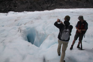 Fox-Glacier-heli-hike-deep-crevasse-taking-photo