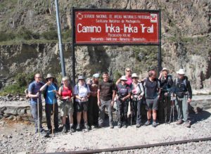 train-to-Machu-Picchu-trekkers-in-front-of-sign-Km82