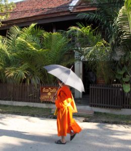 Laos-Luang-Prabang-Lotus-villa-monk-on-street-in-front