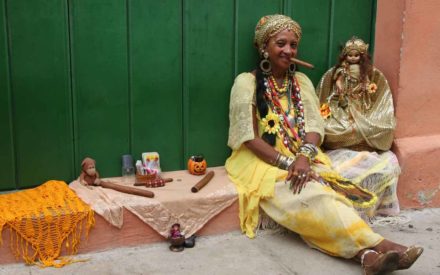 Cuba-Havana-colorful-woman-sitting-in-doorway