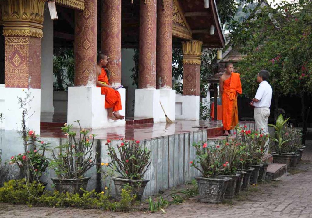 Laos-Luang-prabang-monks-talking-with-visitor