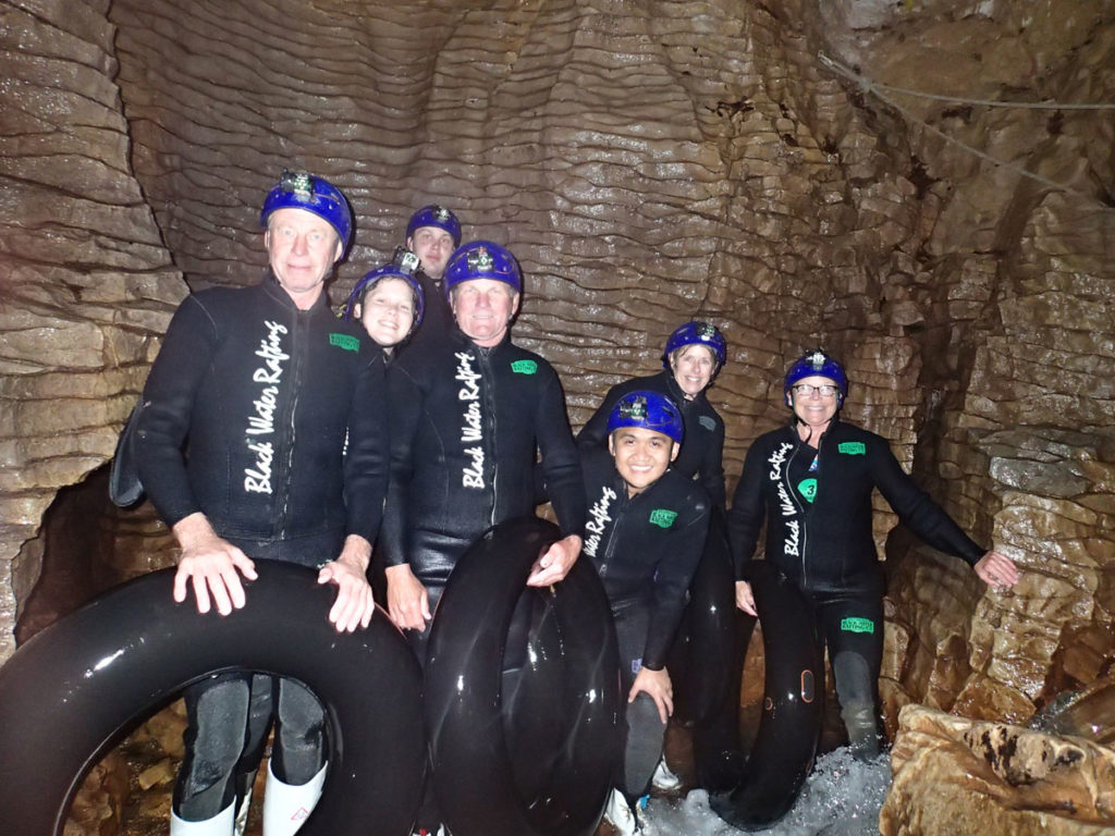 waitomo-caves-black-water-rafting-group-photo-inside-cave